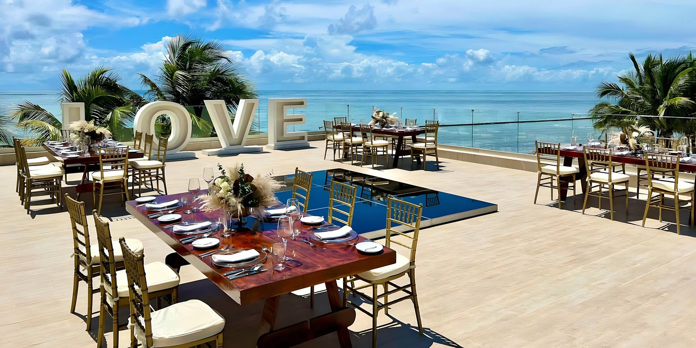 Love Terrace venue at Breathless Riviera Cancun set up for a private event with ocean views and elegant table settings