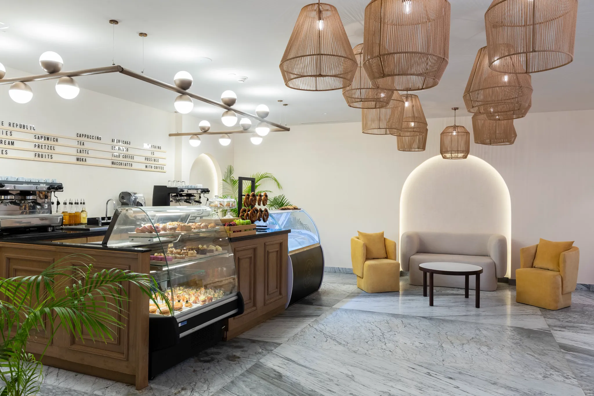 Coffee Republic café at Hyatt Zilara Riviera Maya featuring a modern coffee bar, pastry display case, and cozy lounge seating with warm lighting.