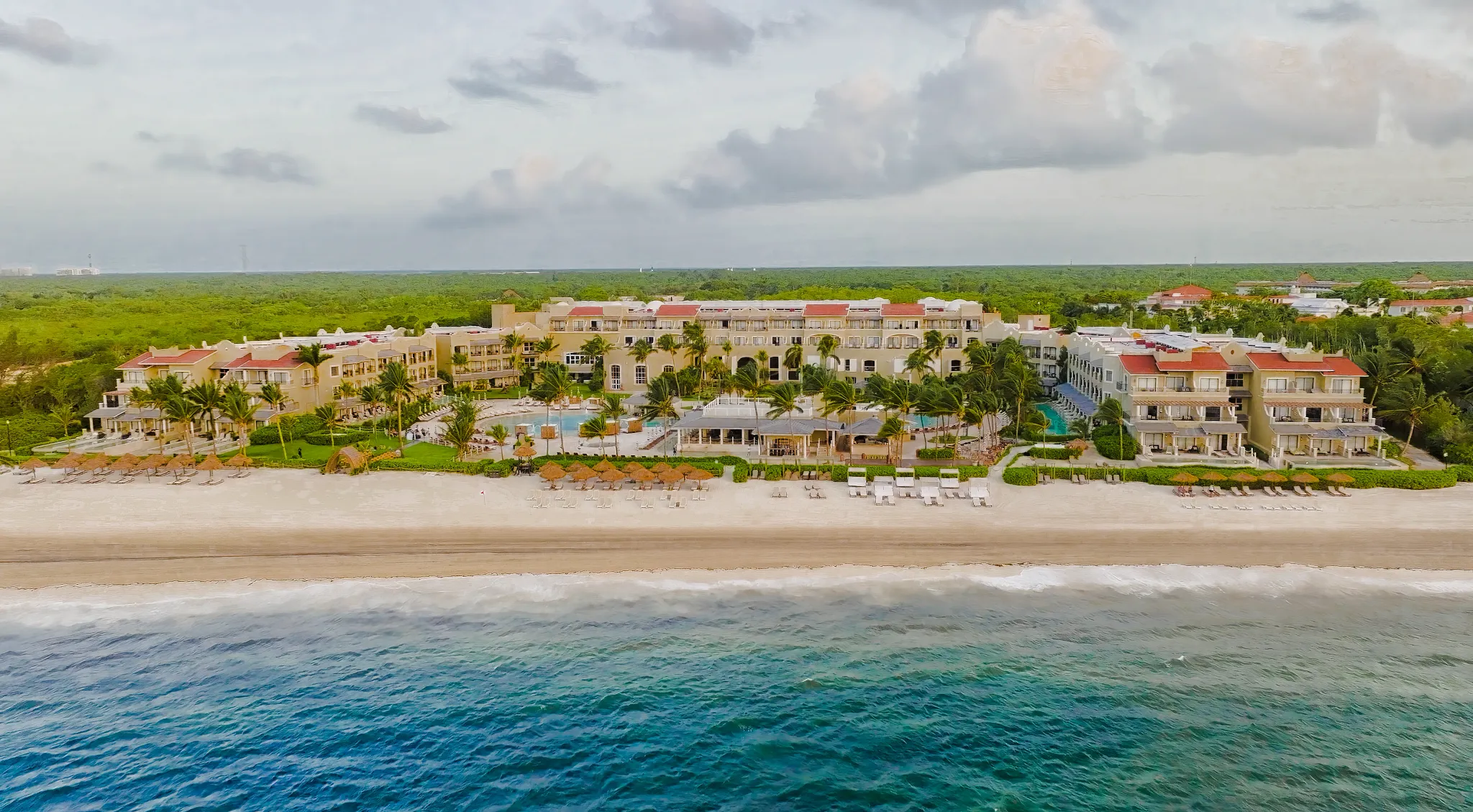 Aerial view of Hyatt Zilara Riviera Maya beachfront resort with white sand beach, turquoise Caribbean Sea, and lush tropical surroundings.