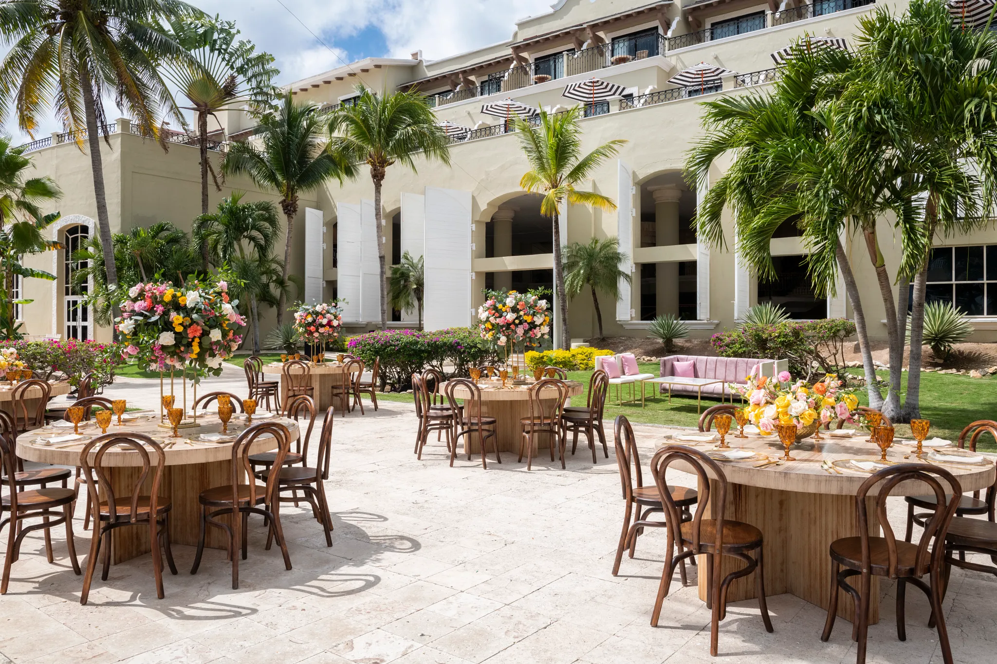 Elegant outdoor event setup with floral centerpieces and wooden tables at Hyatt Zilara Riviera Maya, ideal for weddings and private celebrations.