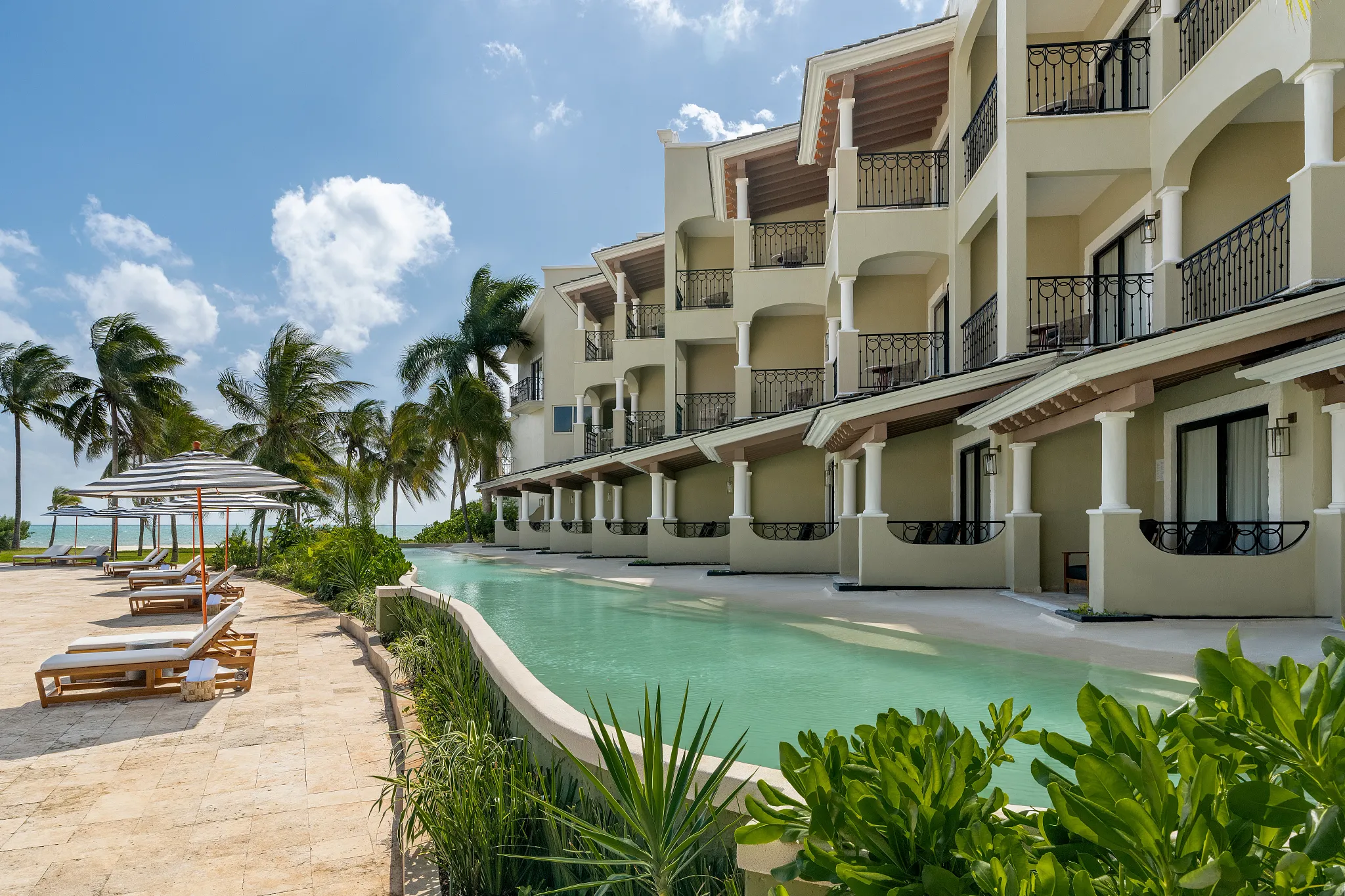 Swim-up suite with direct pool access and private terrace at Hyatt Zilara Riviera Maya overlooking tropical gardens and the beach.
