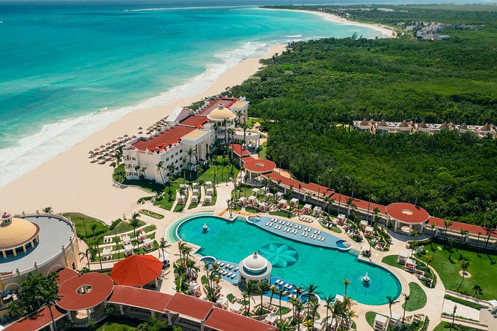 Iberostar Grand Paraiso adults-only all-inclusive resort with colonial architecture, lush gardens, and beachfront luxury near Playa del Carmen.