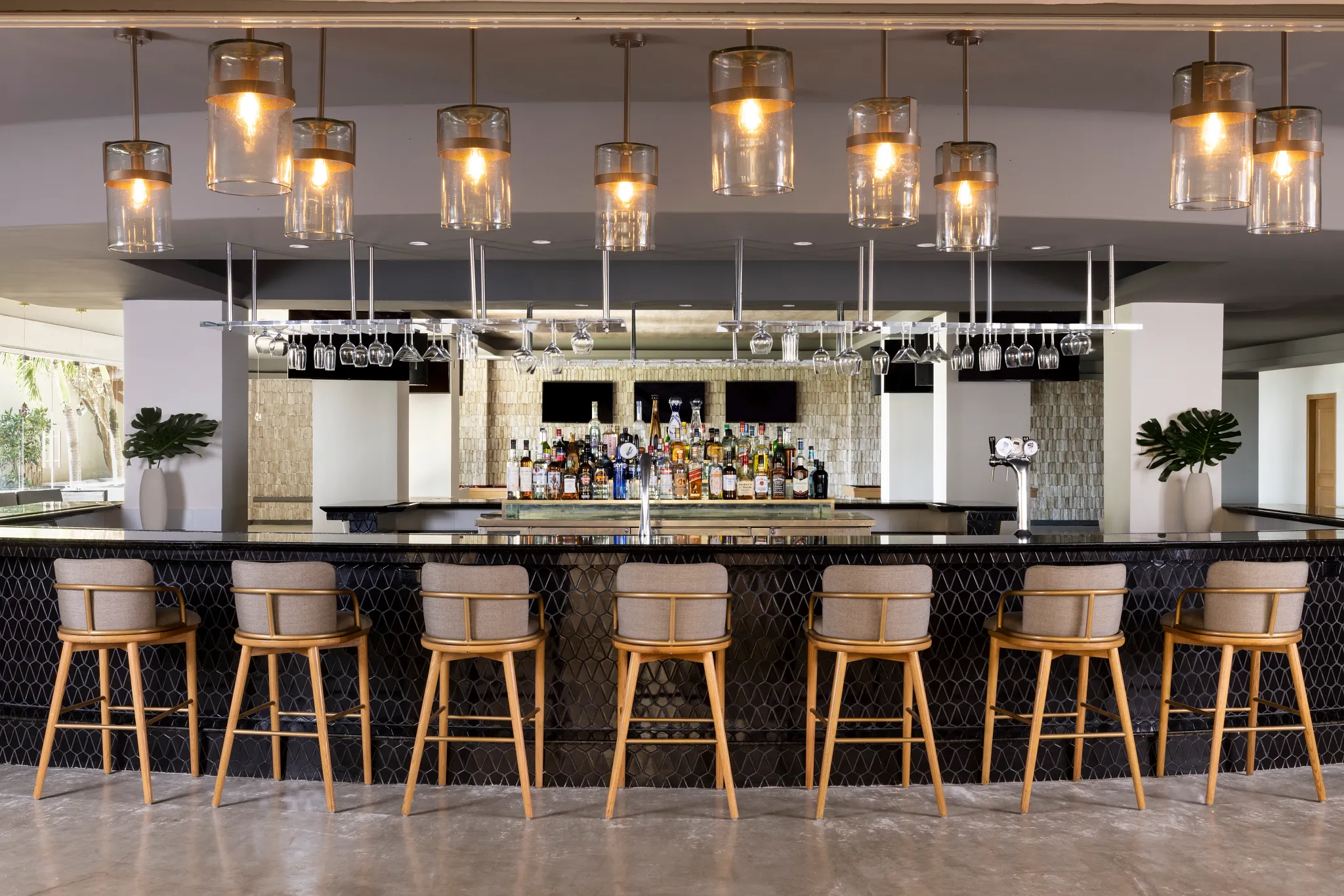 Legends Sports Bar at Hyatt Zilara Riviera Maya featuring a modern bar with high-top seating, premium spirits display, and warm pendant lighting.